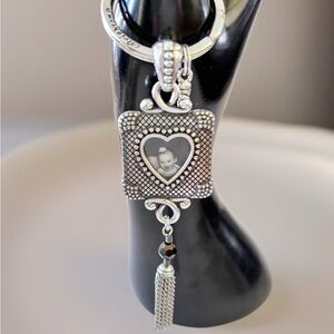 Brighton silver photo frame keychain a heart-shaped locket and a tassel charm.